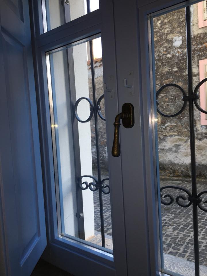Blue window frame with decorative bars – La Porta Blu